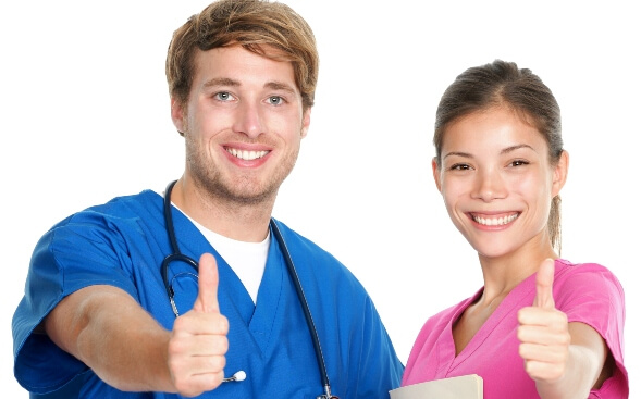 male and female healthcare professionals, both looking at camera, giving thumbs up male and female healthcare professionals, both looking at camera, giving thumbs up