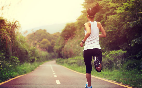 woman jogging on open road woman jogging on open road