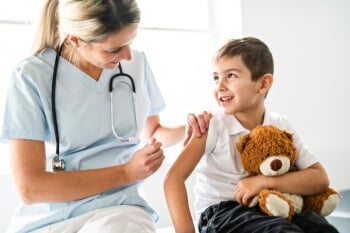 nurse giving injection to pediatric patient holding teddy bear nurse giving injection to pediatric patient holding teddy bear
