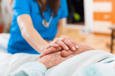 nurse with hands on top of patient's hands nurse with hands on top of patient's hands