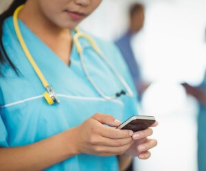 close up of nurse on smart phone close up of nurse on smart phone