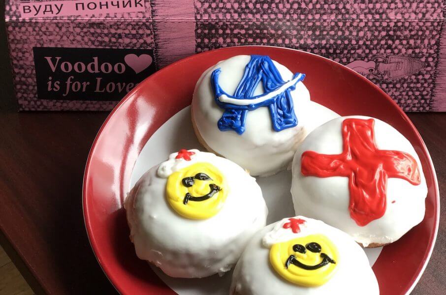 4 donuts on plate with medical symbols in frosting on them 4 donuts on plate with medical symbols in frosting on them