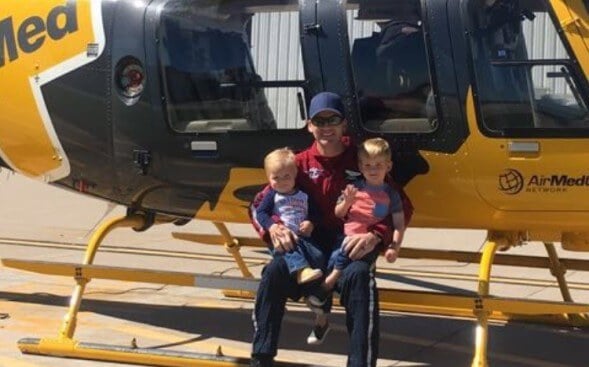Bryan Witham with two children on edge of helicopter Bryan Witham with two children on edge of helicopter