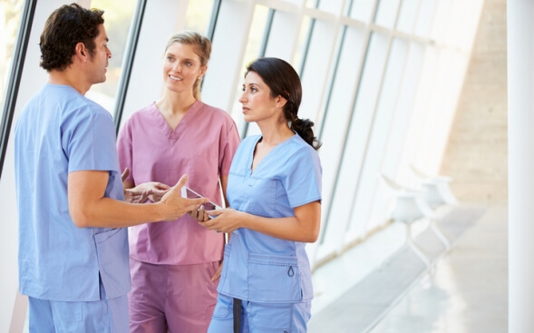 nursing colleagues talking in hallway nursing colleagues talking in hallway