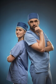 Male and female healthcare professionals standing back to back Male and female healthcare professionals standing back to back