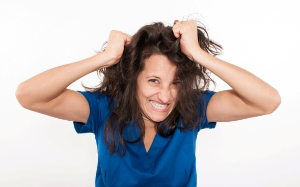 frustrated nurse pulling at her hair frustrated nurse pulling at her hair