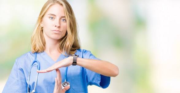 Serious nurse holding hands to indicate a time out Serious nurse holding hands to indicate a time out