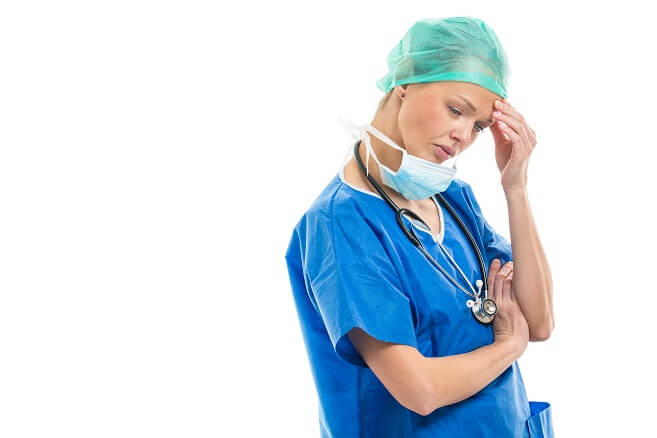 Upset, stressed nurse massaging temple Upset, stressed nurse massaging temple