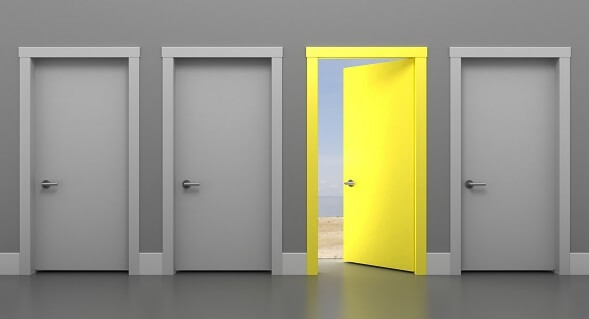 3 closed grey doors and one open yellow door 3 closed grey doors and one open yellow door
