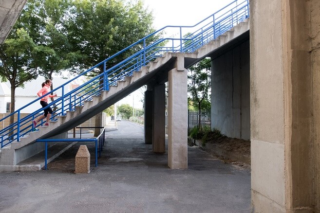 Woman going up outdoor staircase Woman going up outdoor staircase