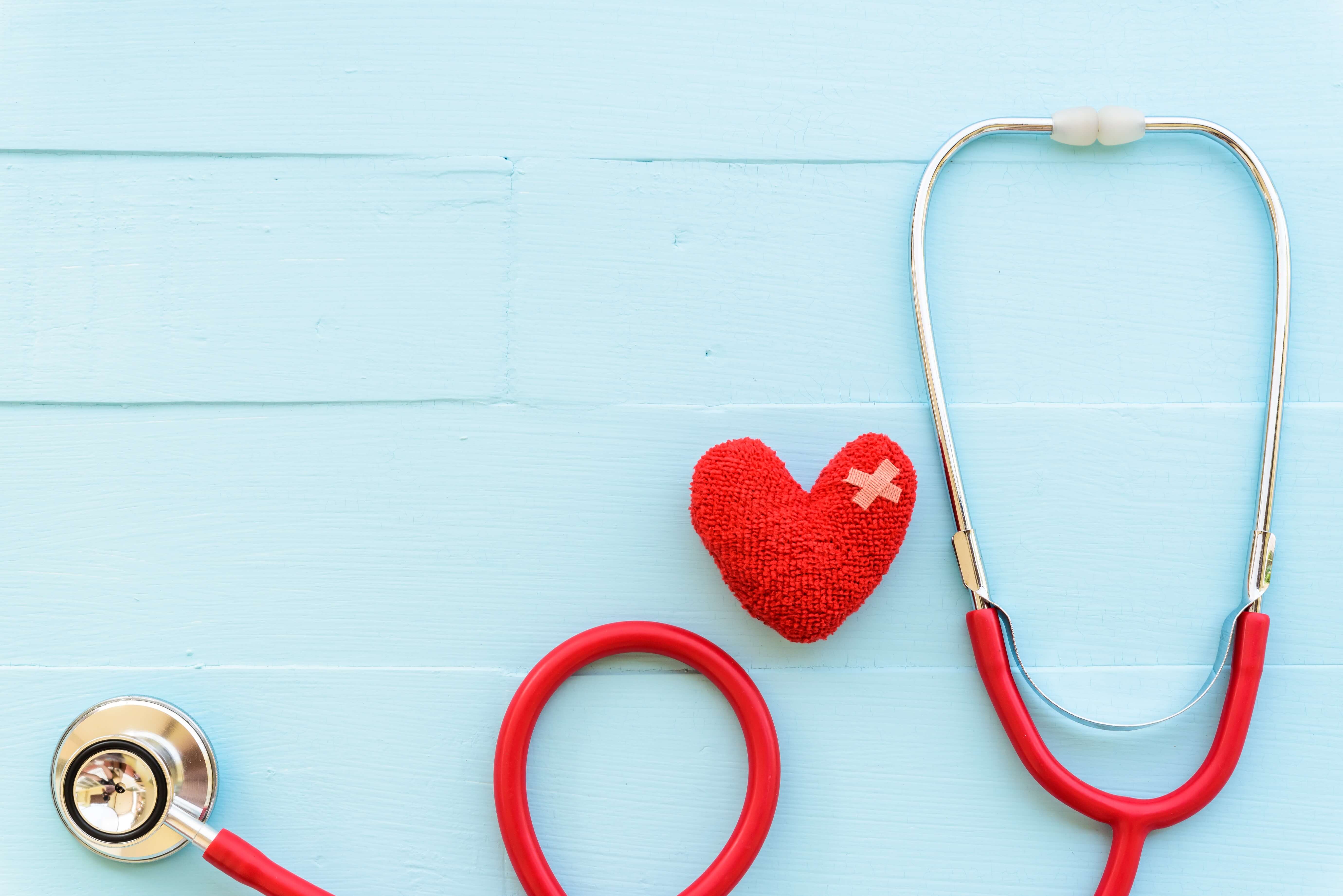 Blue background with red heart and red stethoscope Blue background with red heart and red stethoscope