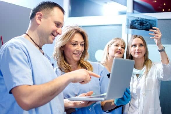 healthcare workers looking at medical files healthcare workers looking at medical files