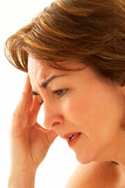 Woman with headache holding temple Woman with headache holding temple