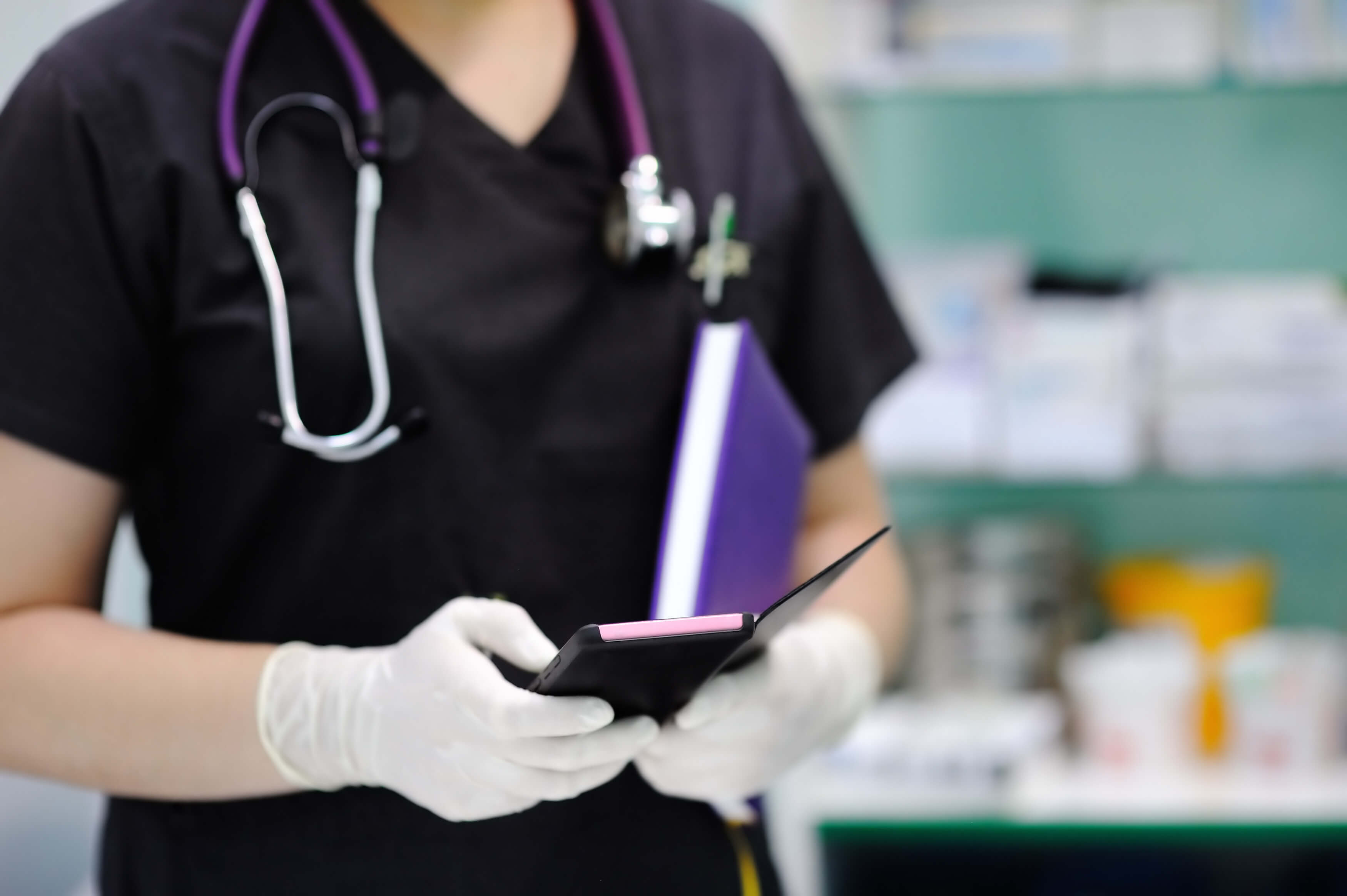 nurse typing on cell with gloved hands nurse typing on cell with gloved hands