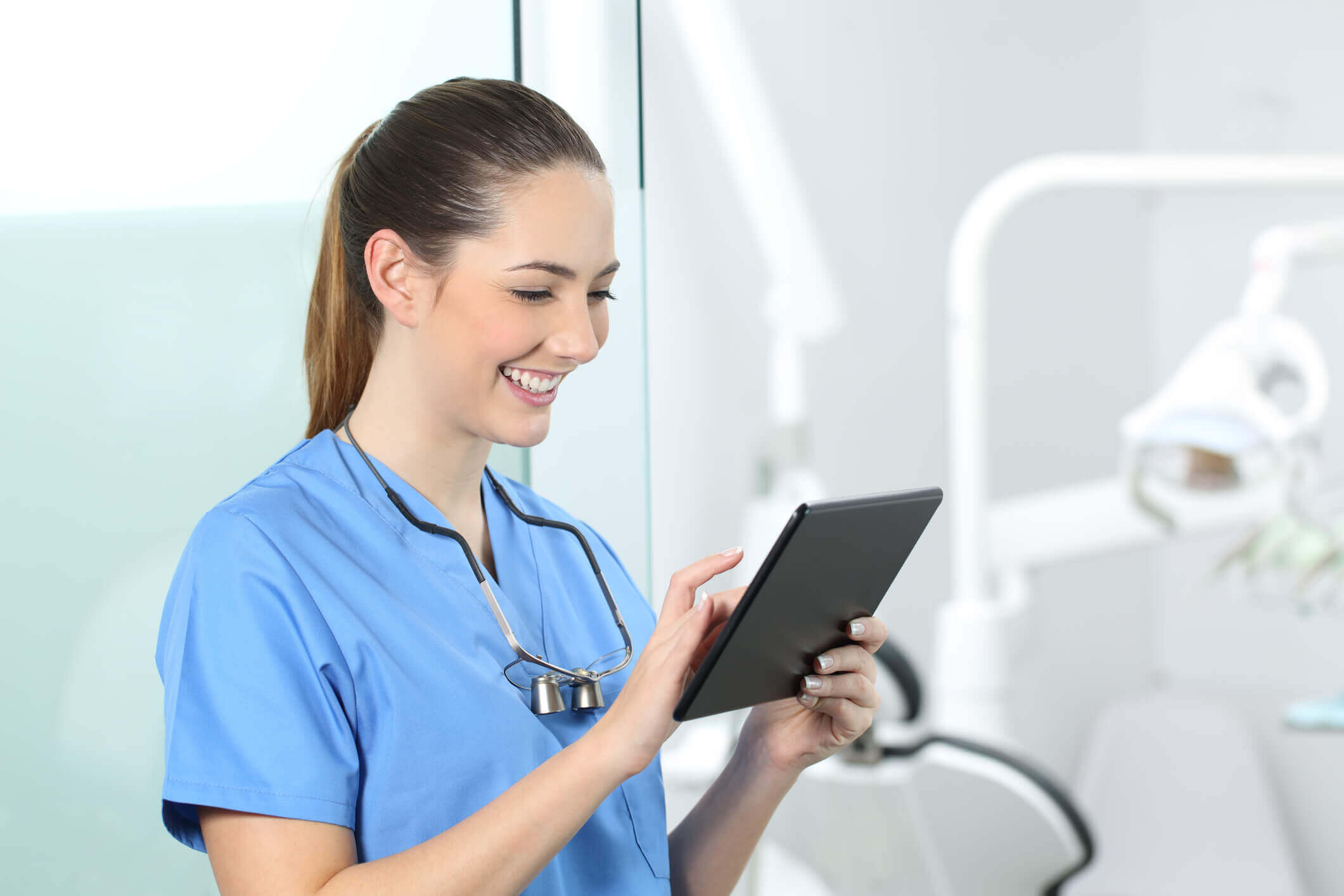 smiling nurses looking at tablet smiling nurses looking at tablet