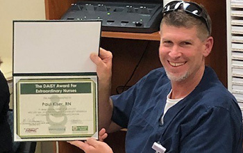 Paul Kiser showing Daisy award certificate Paul Kiser showing Daisy award certificate