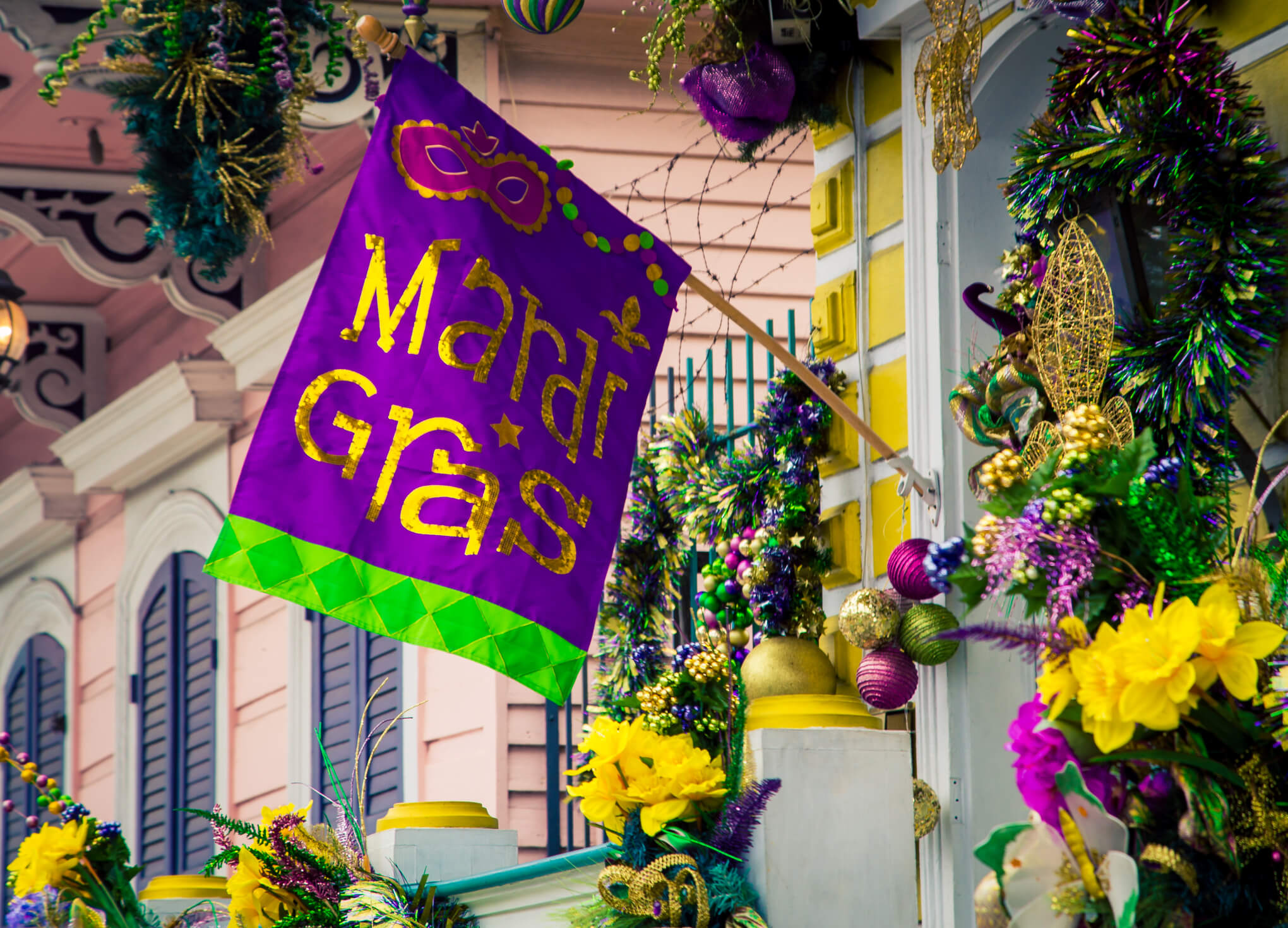 mardi gras flag hanging with flowers mardi gras flag hanging with flowers