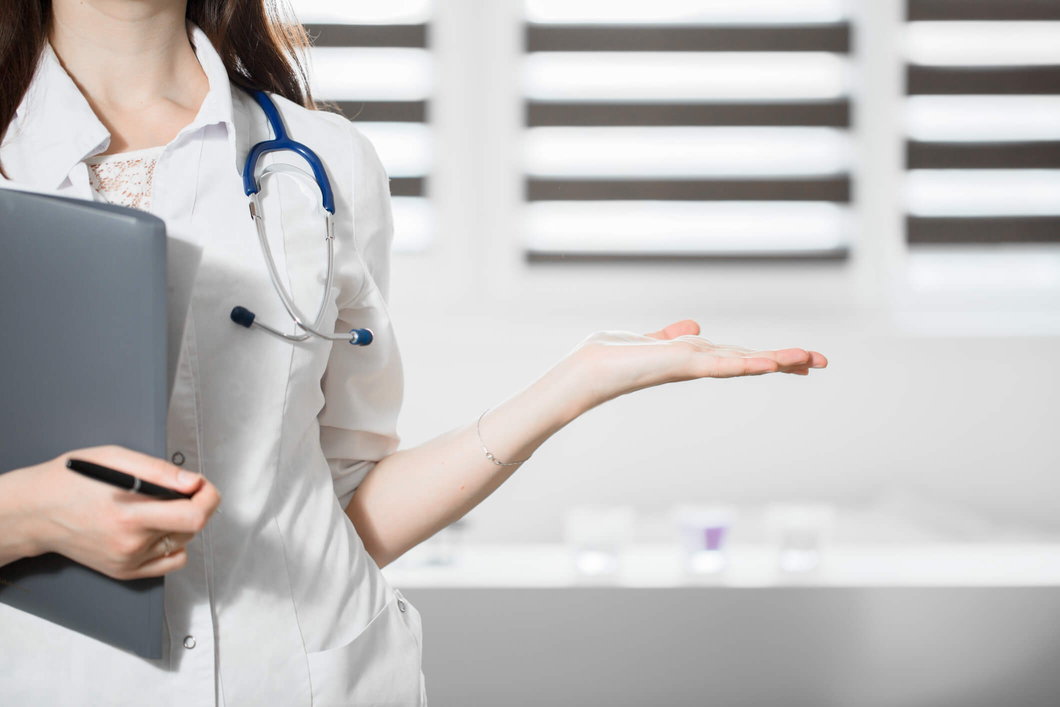 healthcare professional holding one hand out palm up healthcare professional holding one hand out palm up