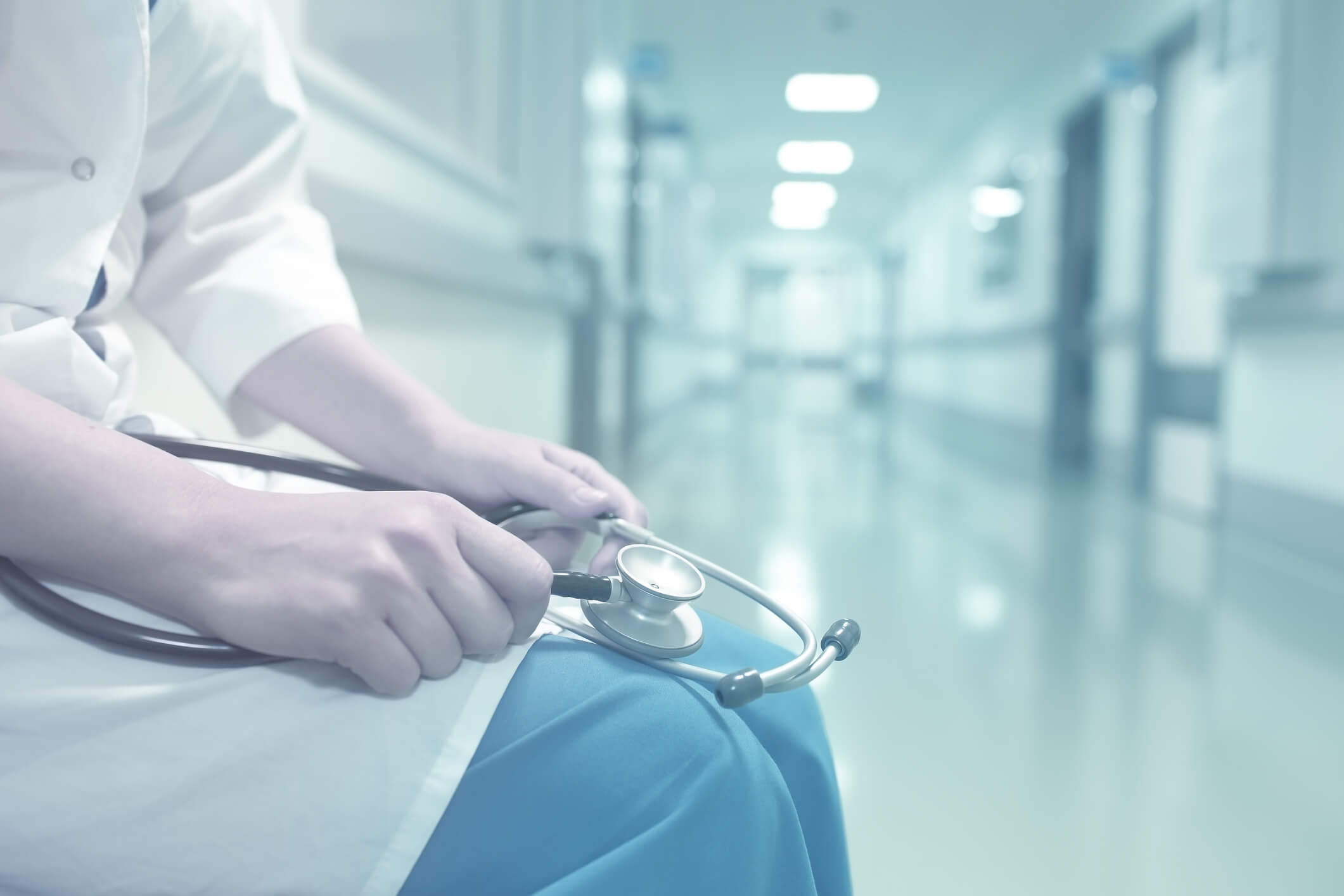 nurse sitting holding stethoscope nurse sitting holding stethoscope