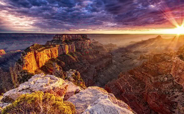 sun setting over canyon and rocks sun setting over canyon and rocks