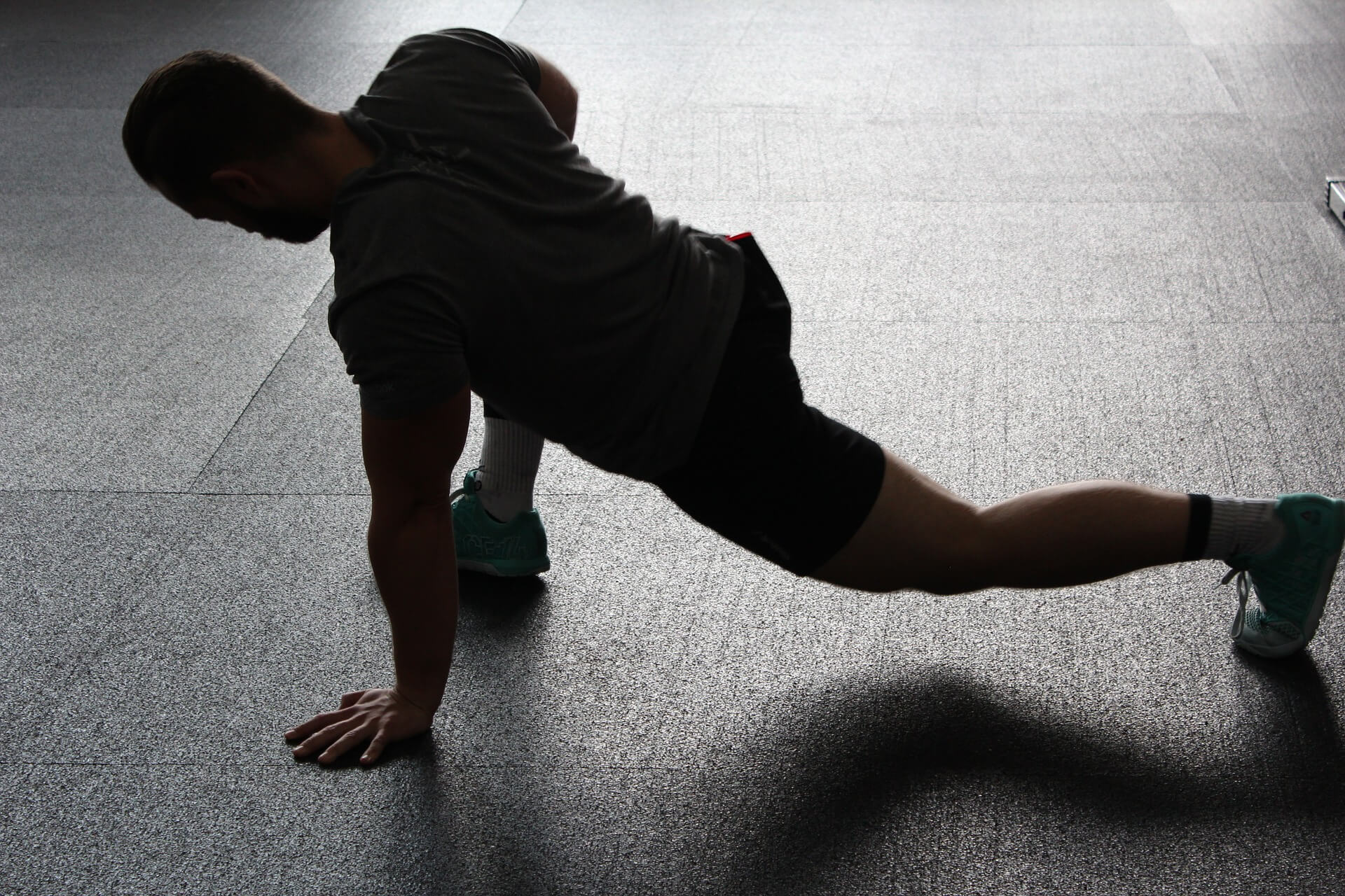 person in shadows stretching legs person in shadows stretching legs