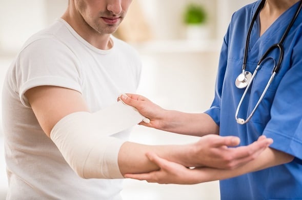 Nurse wrapping patient arm Nurse wrapping patient arm