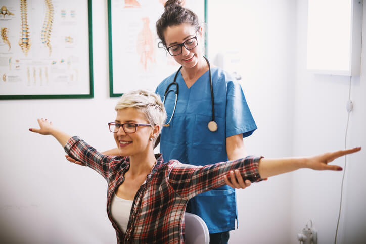 healthcare professional doing physical therapy with patient healthcare professional doing physical therapy with patient