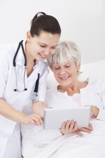 nurse and senior patient smiling at tablet screen nurse and senior patient smiling at tablet screen