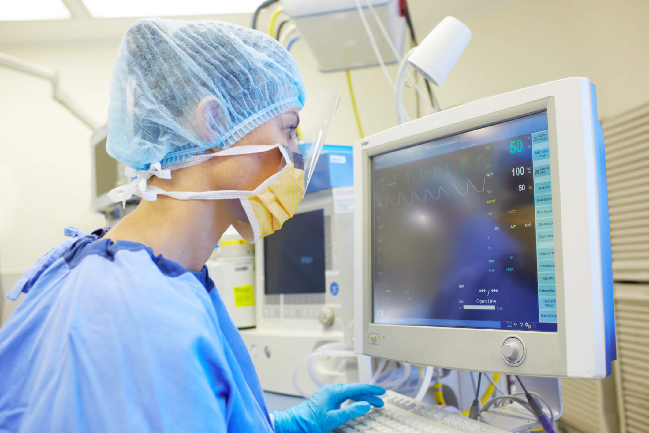 nurse looking at medical equipment read out nurse looking at medical equipment read out