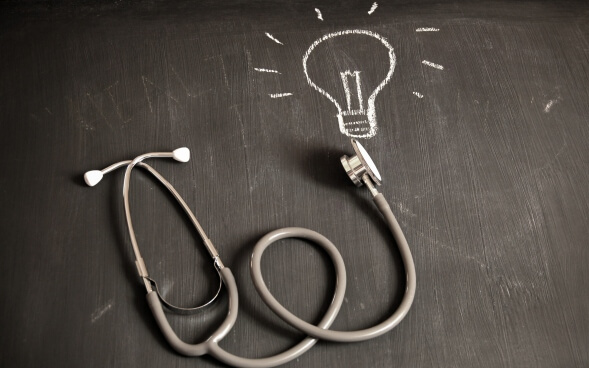 stethoscope ending on chalk drawing of lightbulb stethoscope ending on chalk drawing of lightbulb