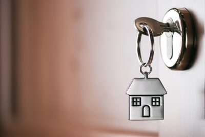house shaped keyring hanging out of door house shaped keyring hanging out of door