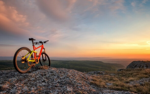 mountain bike on top of mountain at sunset mountain bike on top of mountain at sunset