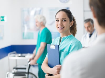 Smiling nurse holding folder Smiling nurse holding folder