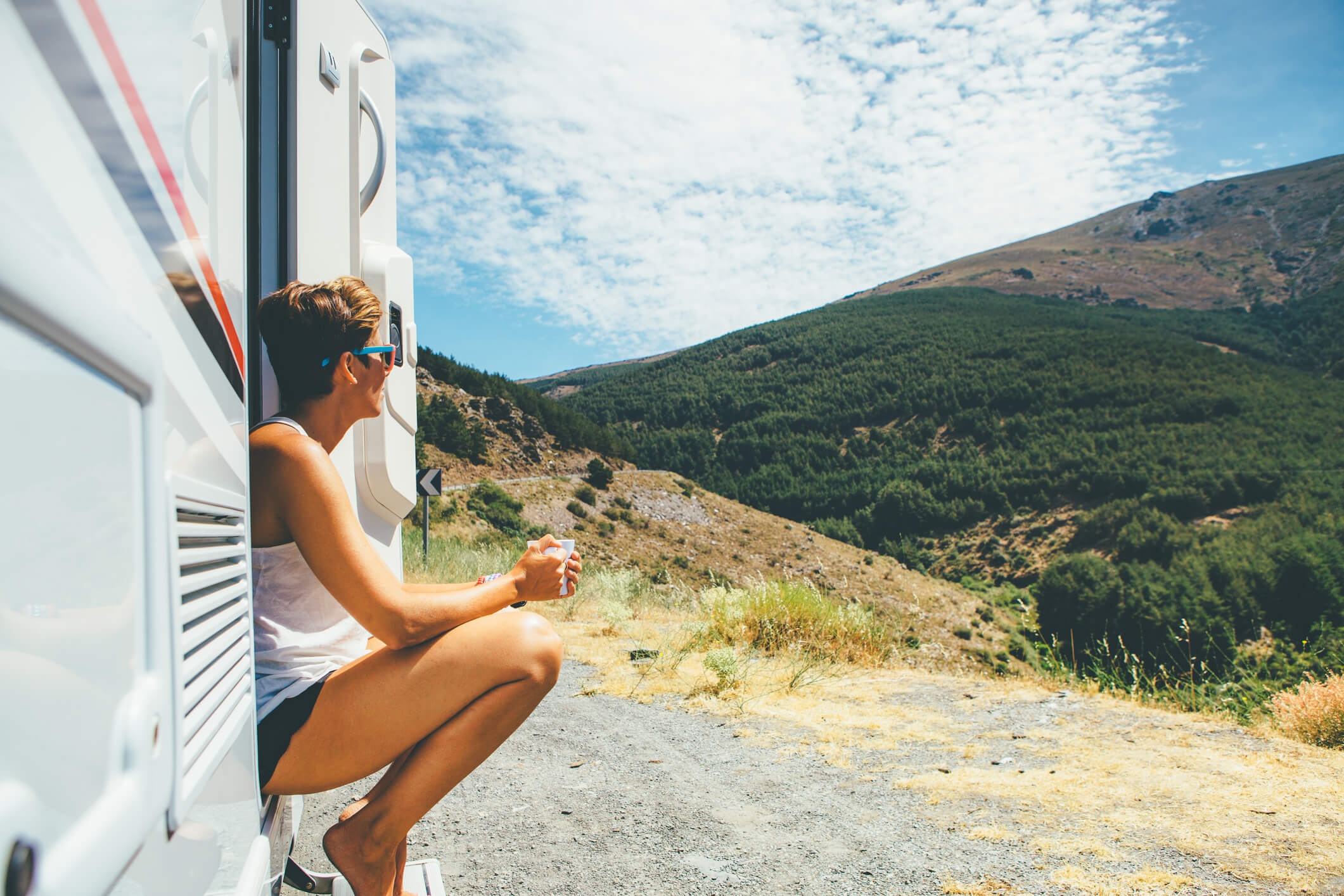 woman sitting in doorway of travel trailer woman sitting in doorway of travel trailer