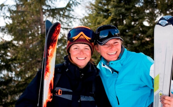 two smiling female skiers two smiling female skiers