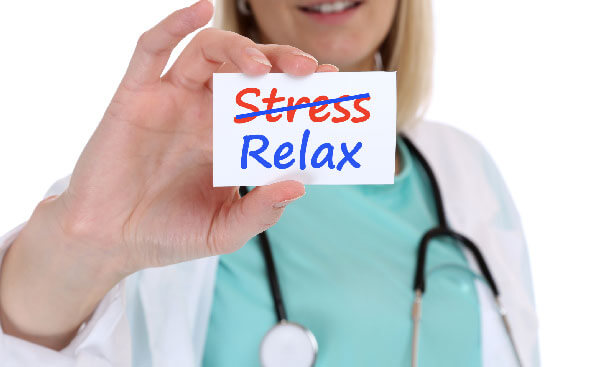 healthcare professional holding up card with words stress and relax on it healthcare professional holding up card with words stress and relax on it
