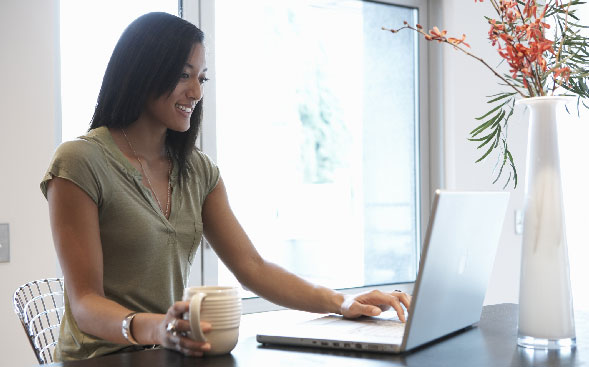 woman at home desk working on laptop woman at home desk working on laptop
