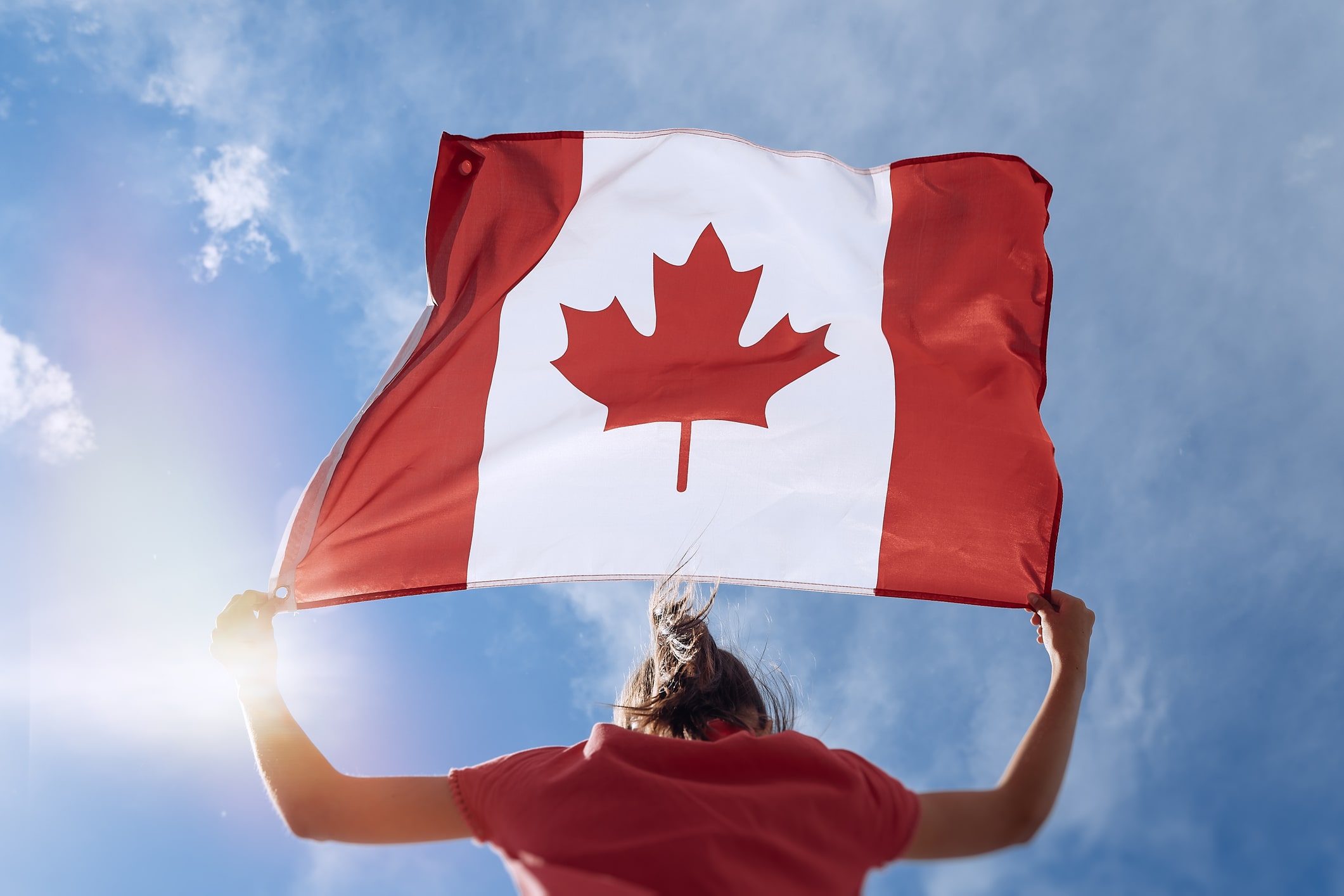 Person waving a Canadian flag Person waving a Canadian flag