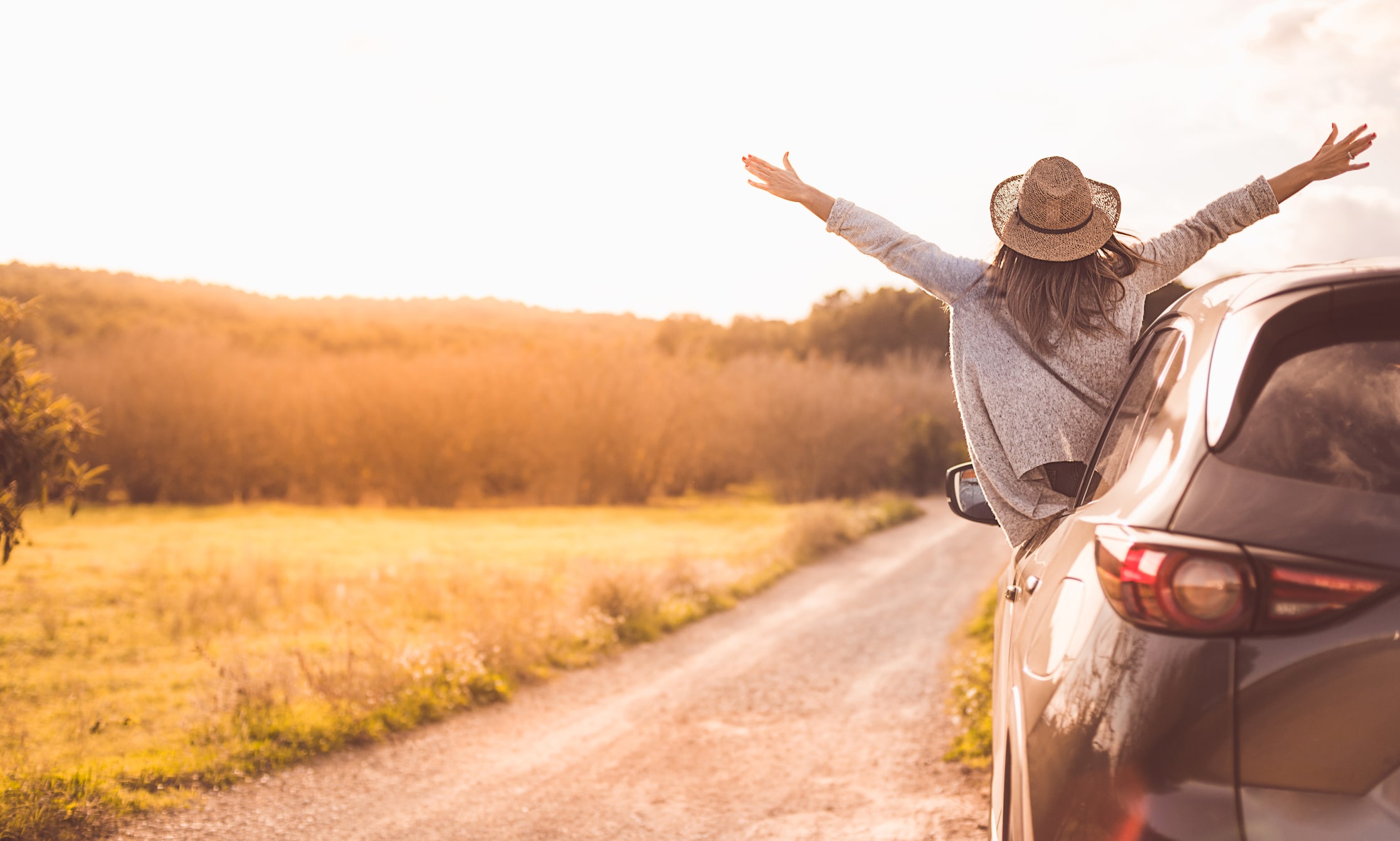 Happy female wearing a hat and her arms are outstretched. Happy female wearing a hat and her arms are outstretched.